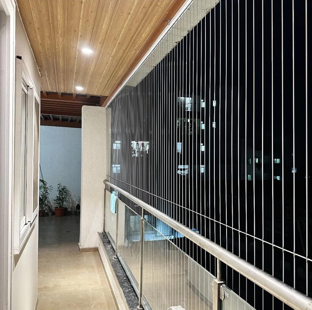 Invisible safety grill installed along an apartment balcony